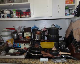 Kitchen items, cookware, mugs, knives and Kuerig K cups.