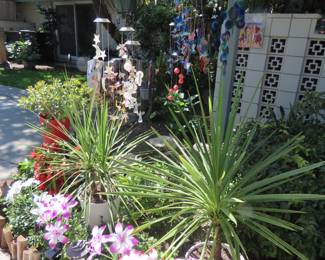 Solar light flowers, garden flags, so many windchimes and plants.