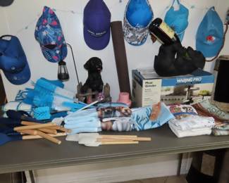 Baseball caps and visors from travel destinations and brand new kitchen items.