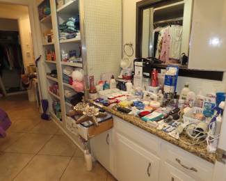 Shelves of personal hygiene items, towels, bed linens, cleaning supplies.