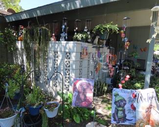 Solar light flowers, garden flags, so many windchimes and plants.
