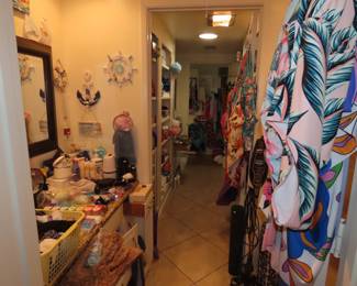 Shelves of personal hygiene items, towels, bed linens, cleaning supplies and swimsuits.