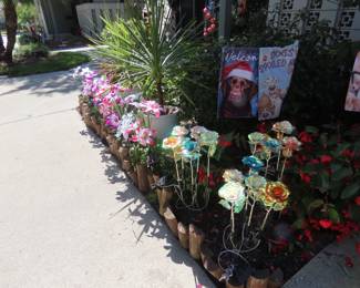 Solar light flowers, garden flags, so many windchimes and plants.