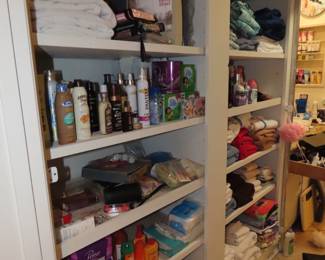 Shelves of personal hygiene items, towels, bed linens, cleaning supplies.