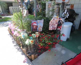 Solar light flowers, garden flags, so many windchimes and plants.