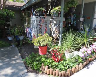 Solar light flowers, garden flags, so many windchimes and plants.
