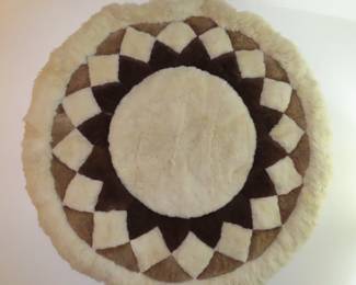 Round sheepskin rug.