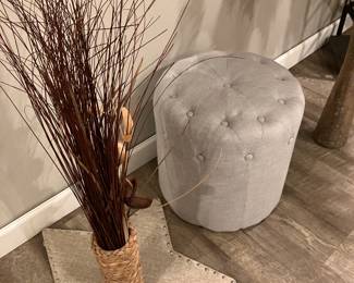 Upholstered round low stool and decorative items