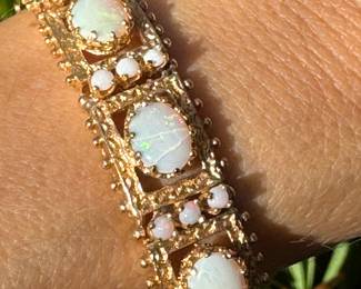 $1,650 - One 14kt gold ladies opal hinged bracelet that contains 4 cabochon cut opals that are white in color and 9 round cabochon. The bracelet weight 26.60 grams including stones. Bere Appraisal included with your purchase.