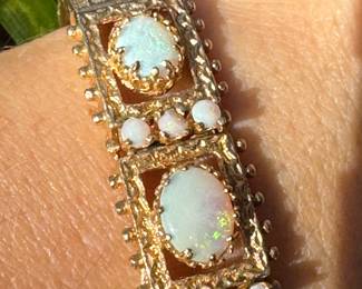 $1,650 - One 14kt gold ladies opal hinged bracelet that contains 4 cabochon cut opals that are white in color and 9 round cabochon. The bracelet weight 26.60 grams including stones. Bere Appraisal included with your purchase.