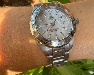 $750 - One ladies Tag Hauer stainless steel Aquaracer . Way 1412 - Serial RZE6771 - watch has mother of pearl dial, rotating bezel, sapphire crystal and the BA0920 stainless steel bracelet. Bere Appraisal included with your purchase.