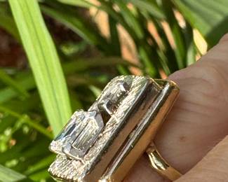 $3,250 - One 14kt yellow gold ladies diamond ring that contains one (1) emerald cut diamond that measures approx. 1.34 carats. Also one baguette cut diamond 0.16ct. The Diamonds are "G-H" in color and "VS2" in clarity. The ring weights 7.60 grams including the stones. combined weight of both stones 1.50 carats.
