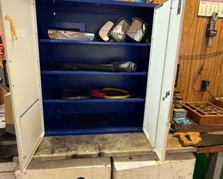 The top is a steel cabinet made to be wall, mounted with three shelves on the inside