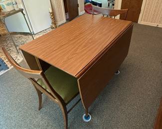 This is a beautiful mid-century, modern drop leaf dining room table and chairs! There are four chairs with the set and it comes with a leaf for the table!