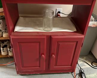 #97 red painted microwave stand with2 doors and open shelf 27x17x24 as is finish $30.00
