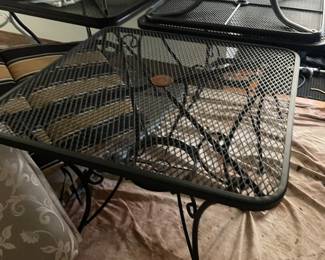 Several 2 seater tables with chairs and cushions