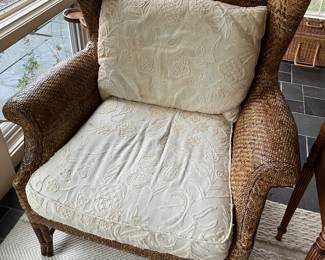 Closer view of one of two matching Baker Furniture “Milling Road” rattan chairs.
