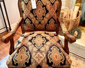 $450. Wooden armchair with custom upholstery. Scrolled arms, front twisted wood. 28 x 26x 42H.