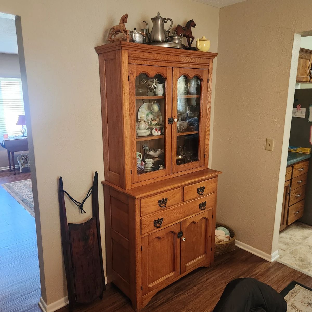 Old sled and antique cabinet filled with goodies, Fenton, etc.