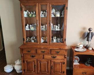 China cabinet filled with figurines, precious moments, and vintage wares
