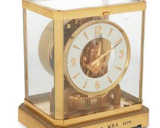 1130
Mid-20th century
A Jaeger-LeCoultre "Atmos" mantel clock
Marked to central gearbox: Atmos / LeCoultre &Cie / Switzerland / Fifteen 15 Jewels VXN / Switzerland Unadjusted; further marked to top of instruments: Le Coultre / Atmos / 300091; marked again to underside: LeCoultre & Cie / Metal / Caliber 523-3
The gold-plated metal and brass mantel clock with torsion pendulum regulator and white dial bearing Arabic numerals, housed in a glass and gilt brass case, including original pamphlets and manual, personalized
9.25" H x 8.25" W x 6.375" D
Estimate: $300 - $400