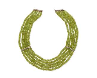 1041
A Silver, Peridot and Diamond Necklace
Featuring five strands of faceted peridot beads, accented by diamond set silver stations and finished with a silver clasp
Length: 16-18 in.
148.2 grams gross
Estimate: $700 - $900