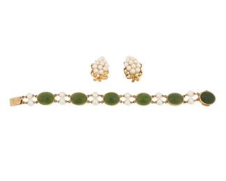 1022
A Gold, Jade and Cultured Pearl Bracelet and Earrings
Including a 14k gold, oval nephrite jade cabochon and cultured pearl bracelet, signed Gumps, together with a pair of 14k gold and cultured pearl grape earrings
3 pieces
Length: 7 1/4in., Earrings: 1 in.
33.3 grams gross
Estimate: $800 - $1,200
