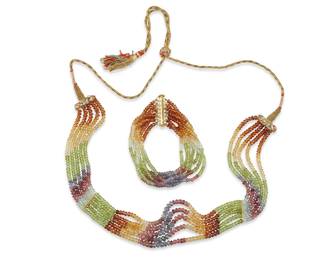 1032
A Multi-strand Gemstone Necklace Set
Comprising a rainbow necklace with multiple strands of multicolored gemstones on gold and silk thread, together with a matching bracelet
2 pieces
Lengths: 30 in. and 7 1/2 in.
Estimate: $500 - $700