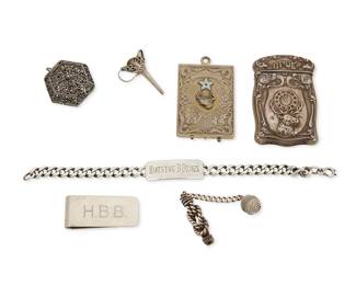 1114
A Group of Silver Personal Accessories
20th century
Four variously marked for maker and for sterling, three unmarked
Comprising two B.P.O.E. sterling silver card cases, including an Alfred Schickerling hinged case with vermeil finish and enamel star accent, and an Art Nouveau-style repoussé case with hinged lid, together with an intricate Italian sterling silver filigree pomander pendant, a sterling silver chain link i.d. bracelet, a money clip, a silver funnel, and a nautical knotwork charm with twisted rope ball, 3 personalized
7 pieces
Largest: 2 5/8 in. x 1 5/8 in.; smallest: 1 3/8 in. x 7/8 in. Dia.
130.2 grams gross
Estimate: $400 - $600