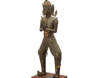 1176
19th century
A Thai bronze teppanom figure
The temple guardian angel figure with elaborate headdress, depicted with hands clasped together in prayer, with remnants of gilding throughout, mounted on a wood plinth
Figure: 25.25" H x 7.75" W x 4.25" D; Overall: 28.25" H x 8.25" W x 5.875" D
Estimate: $200 - $300