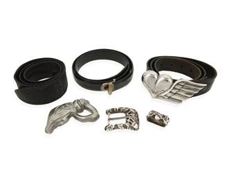 1110
A Group of Belt Buckles and Leather Belts
Late 20th century
Three variously marked for maker and for sterling
Comprising a Stephen Dweck sterling silver buckle with matching keeper, each with elaborate oak leaf and acorn silver overlay designs, a Bijan sterling silver vermeil modernist style buckle attached to a smooth black leather belt, a King Baby winged heart silver metal buckle with a King Baby black leather belt, size 32, and an unmarked cast silver metal snake head buckle with a wide textured black suede leather belt, 6 pieces
Largest buckle: 2 1/4 in. H x 5 1/4 in. W; smallest: 1 1/2 in. H x 1 /1/4 in. W; belts: 38 in. L x 2 in. H; 38 in. L x 1 1/2 in. H; 35 in. L x 1 1/8 in. H
684.1 grams gross
Estimate: $400 - $600
