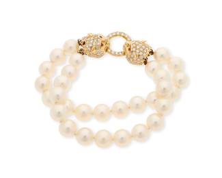 1015
A Gold and Cultured Pearl Bracelet
Featuring two strands of cultured pearls measuring approximately 8.60 mm, finished with a cat head style clasp set with round diamonds and rubies
Measures: 6 in.
36.0 grams gross
Estimate: $1,000 - $2,000
