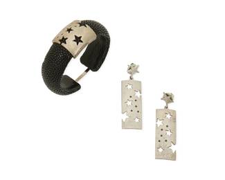 1122
A Set of Sterling Silver and Shagreen Jewelry
A dark grey galuchat stingray leather cuff bracelet with etched sterling silver star motif accent and round black diamonds and delicate clasp, with a pair of matching silver earrings, each marked GH for maker and for sterling, 3 pieces
Bracelet inner circumference: 6 1/4 in.; earrings length: 2 3/8 in.
52.2 grams gross
Estimate: $600 - $800