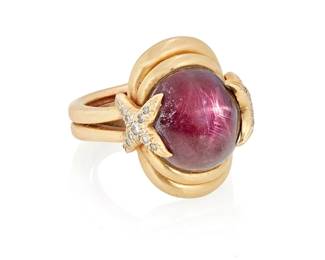 1067
A Gold and Star Ruby Ring
Centering an oval ruby double cabochon measuring approximately 14.71 x 12.60 x 9.87mm, accented by "X" motifs set with round diamonds
Size: 8 3/4 (with sizing spring)
18.4 grams gross
Estimate: $800 - $1,200