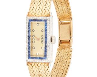 1057
A Gold, Platinum, Sapphire and Diamond Watch
Dial: 7.5mm, rectangular with dot hour markers
Model: Audiget 17 jewels
Case: 13.7 mm, with 14k woven gold strap
Length: 6 in.
32.3 grams gross
Estimate: $1,000 - $2,000