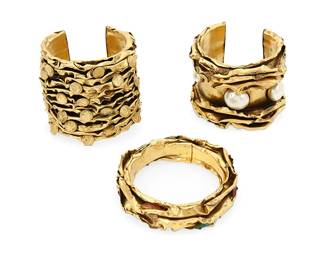 1118
Three Vintage Mixed Metal Cuff Bracelets
Comprising two brutalist-style wide cuffs, and one bangle, each in brass toned metal with ruffled metal ridges, and coin, faux pearl, and diamanté accents, circa 1980s-2000s
3 pieces
Largest: 7 in. inner C x 2 3/4 in. H; smallest: 8 in. inner C x 7/8 in. H
257.1 grams gross
Estimate: $200 - $400