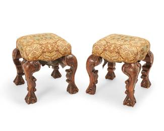 1145
18th century elements
A pair of Baroque-style stools
Each constructed from four exaggerated cabriole legs with scrolled edges and ball-and-claw feet, later converted to stools with seat cushions upholstered in elaborate foliate pattern fabric, 2 pieces
Each: 24" H x 23.5" W x 23.5" D
Estimate: $300 - $500