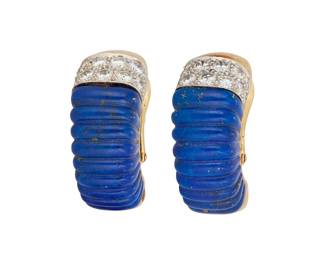 1043
David Webb: A Pair of Gold, Lapis Lazuli and Diamond Earrings
Featuring carved lapis lazuli and round diamond half hoop style earrings, signed Webb
2 pieces
Measures: 1 in.
23.4 grams gross
Estimate: $1,000 - $2,000