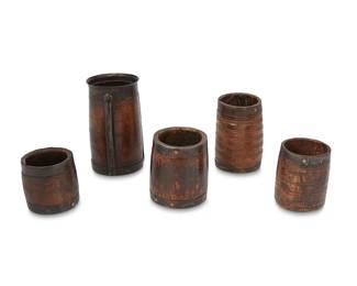 1156
19th century
A group of treen wood and metal barrels
Comprising five antique wood barrels of various sizes, each with metal banding; three with decorative patterns carved into the wood surface, 5 pieces
Largest: 8.5" H x 4.75" Dia.; Smallest: 4.75" H x 3.75" Dia.
Estimate: $100 - $200