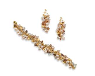 1018
Mignon Faget : A Set of Vintage Pearl and Gemstone Jewelry
A vermeil sterling silver chain bracelet with multi-colored pearl, gemstone, and freeform gold-toned beads together with a pair of matching drop earrings, variously marked for maker and for sterling
3 pieces
Length: 7 in.; earrings: 2 in.
60.7 grams gross
Estimate: $300 - $500