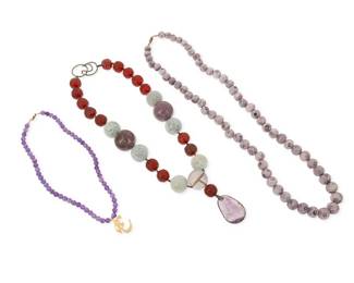 1036
A Group of Gemstone Bead Necklaces
Comprising a chunky necklace with a large amethyst pendant and beads, as well as carved jade and cherry amber beads, together with a single graduated strand of pale purple coral beads, and a single strand necklace of faceted amethyst beads with sterling silver vermeil "om" symbol pendant
3 pieces
Lengths: 31 in.; 22 in.; 17 in.
480.1 grams gross
Estimate: $600 - $800