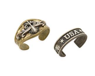 1105
King Baby: Two Sterling Silver Cuff Bracelets
Comprising two chunky cuffs, one in mixed metal brass with an ornate silver overlay motif, and one a narrow cuff with Native American motifs and "USA" silver overlay, each marked: King Baby / .925 / USA
2 pieces
Larger: 6 1/8 in. inner C x 1 5/8 in. H, with a 1 in. gap; smaller: 5 3/4 in. inner C x 3/4 in. H, with a 1 1/4 in. gap
151.2 grams gross
Estimate: $600 - $800