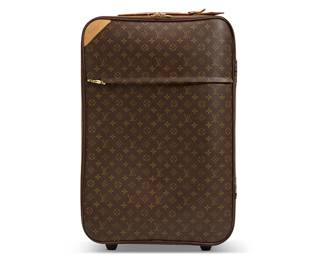 1124
Louis Vuitton: A "Pégase Légère 65" Monogram luggage bag
21st century; France
Marked to leather ID tag holder, interior tag holder, and at front top left on a leather patch: ® / Louis Vuitton / Paris / Made in France; exterior zippers marked: LV; garment bag marked to cloth tag: Louis Vuitton / Paris / Made in France
A roller suitcase with LV Monogram in tan on brown leather, with branded brass hardware, and flat leather handles to top and one side, the exterior with a zippered front compartment revealing an inner nylon canvas pouch, the interior lined in nylon canvas with two zippered pockets, featuring a nylon canvas garment bag
28.25" H x 18.25" W x 10.25" D approximately
Estimate: $200 - $400