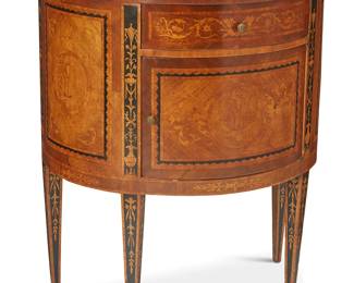 1143
Early 20th century
A George III-style marquetry demilune commode
The Hepplewhite-style small wood demilune cabinet profusely inlaid with satinwood marquetry cornucopias, garlands, and scrolled foliate motifs, featuring a single drawer above a hinged cabinet door, each with brass pulls, raised on tapered legs
29.5" H x 25.25" W x 15.625" D
Estimate: $200 - $300