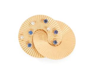 1029
A 14K Gold, Sapphire and Diamond Brooch
Of an interlocking ring design accented by round sapphires and diamonds
Measures: 1 1/2 x 1 1/8 in.
10.4 grams gross
Estimate: $300 - $500