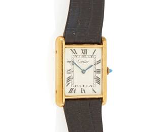 1055
Cartier: A Gold Vermeil Wristwatch
Dial: 16.8mm with Roman numeral hour markers
Case: 23.4mm
Case number: 406901
Closure: black leather strap, with signed box
Inner circumference:8 in.
24.4 grams gross
Estimate: $400 - $600