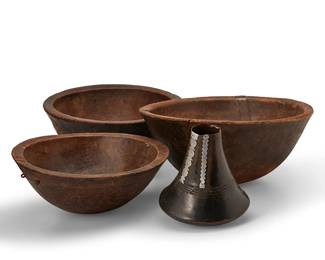 1191
Late 19th century
A group of African carved wood vessels
Comprising three large bowls and a jar with round bottom and attenuated neck, 4 pieces
Largest bowl: 8.125" H x 17.75" Dia.; Jar: 8.75" H x 7.75" Dia.
Estimate: $400 - $600