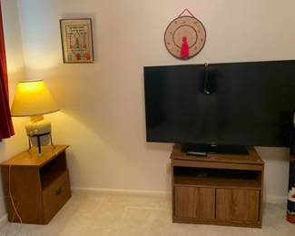 side table, lamp, vintage wall art, TV console with rotating top, Large screen TV