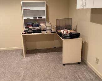 Desk, bookcase, DVDs, CDs, VHS tapes