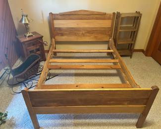 Platform bed frame with end table, bookcase and a sleigh on the left.